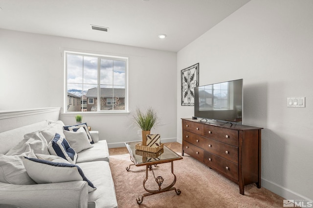 living area with baseboards, visible vents, recessed lighting, and light colored carpet