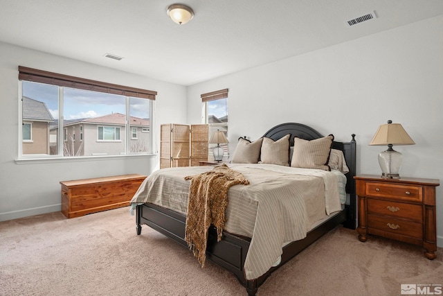 carpeted bedroom with baseboards and visible vents