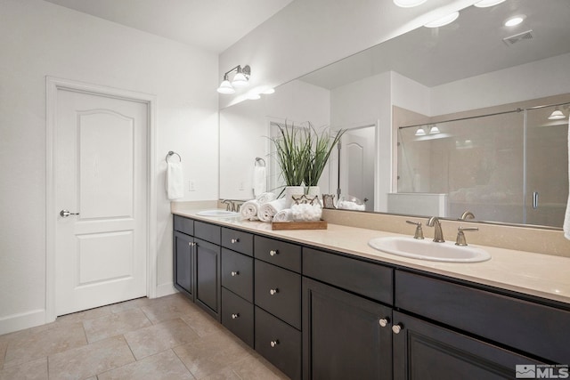full bath featuring a stall shower, double vanity, visible vents, and a sink
