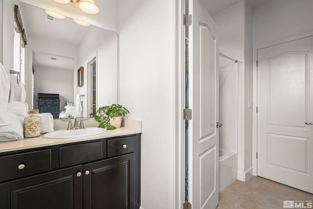 bathroom featuring visible vents, bathing tub / shower combination, tile patterned floors, and vanity