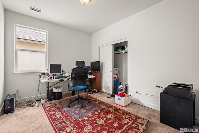 carpeted office featuring baseboards and visible vents