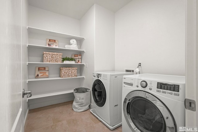 laundry area featuring separate washer and dryer and laundry area