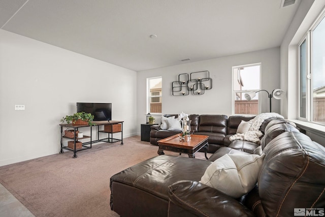 carpeted living room with baseboards and visible vents