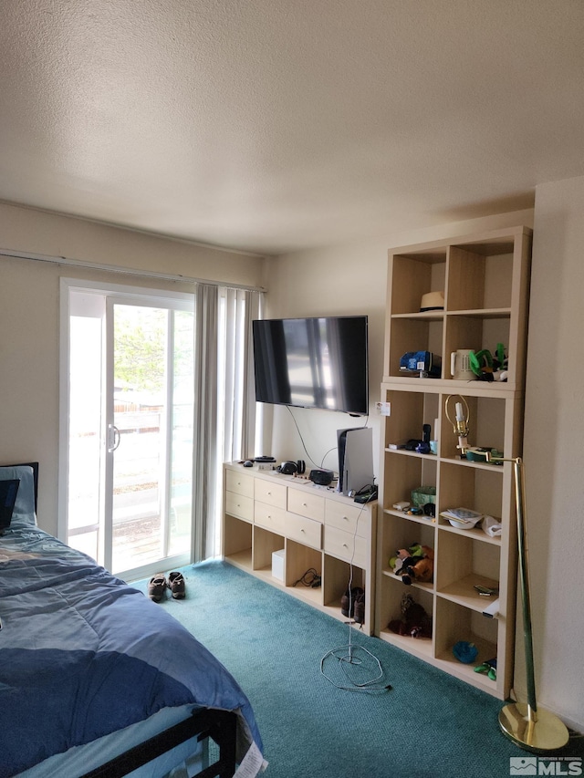 bedroom featuring carpet and a textured ceiling