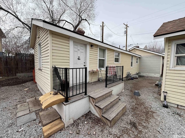 rear view of property featuring fence
