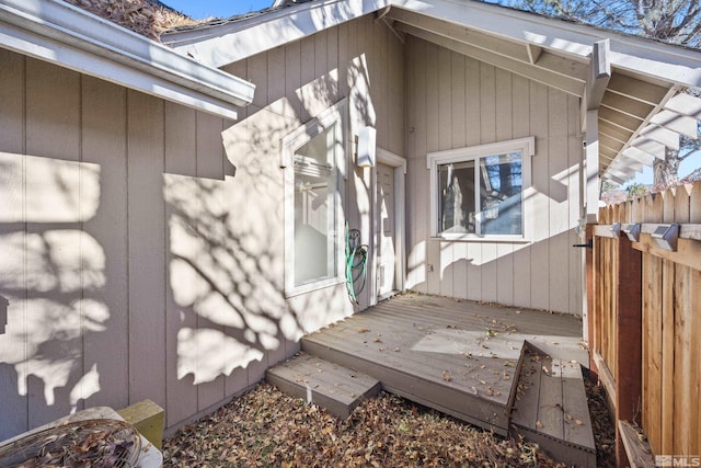 view of side of home with a wooden deck and fence