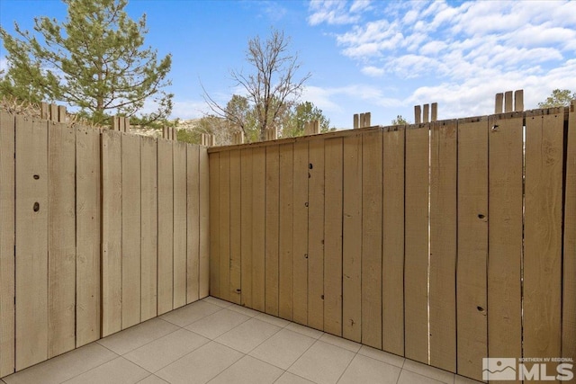 view of patio featuring fence and a gate