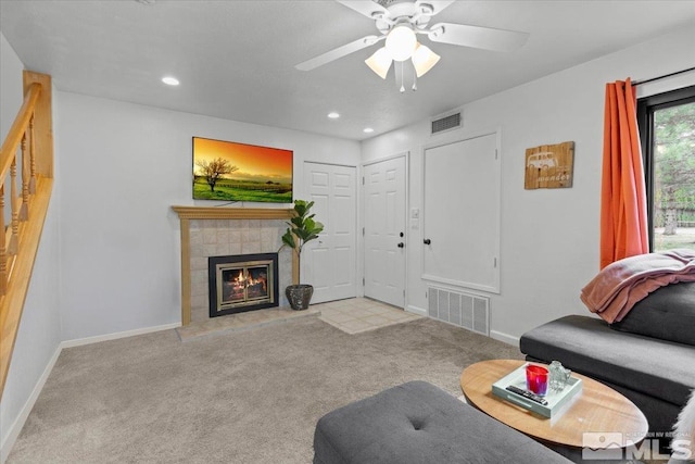 carpeted living room featuring visible vents, baseboards, and a fireplace