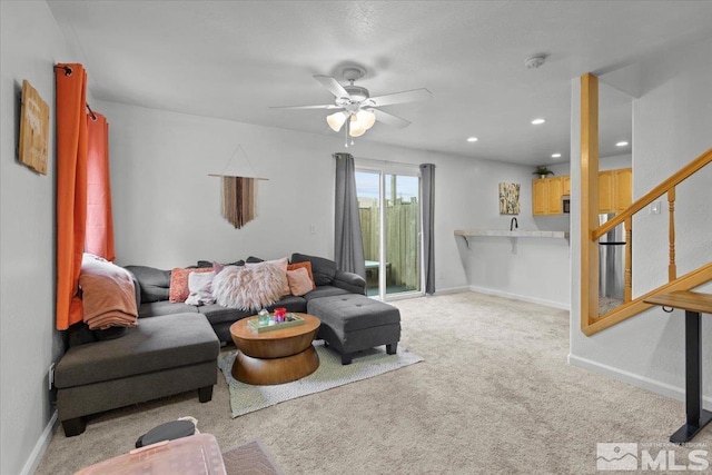 carpeted living area featuring stairs, baseboards, a ceiling fan, and recessed lighting