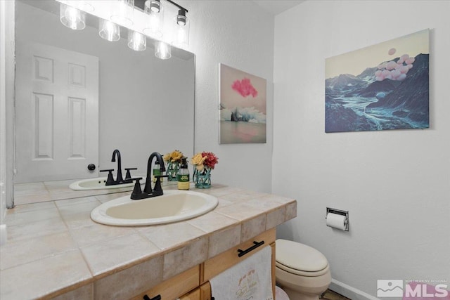half bathroom with toilet and vanity