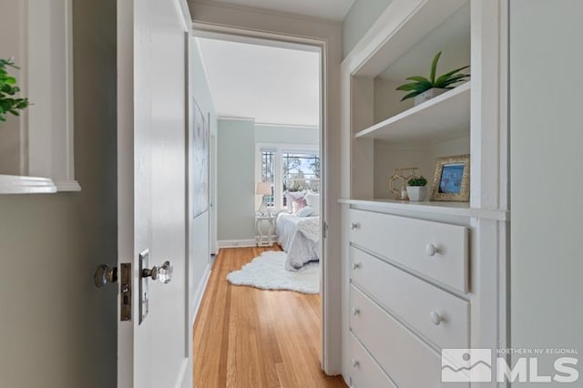 corridor featuring light wood-style floors