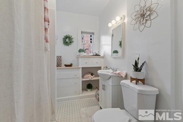 full bathroom with tile patterned flooring, toilet, and vanity