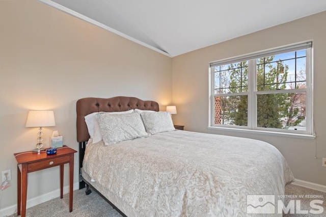 carpeted bedroom featuring baseboards and lofted ceiling