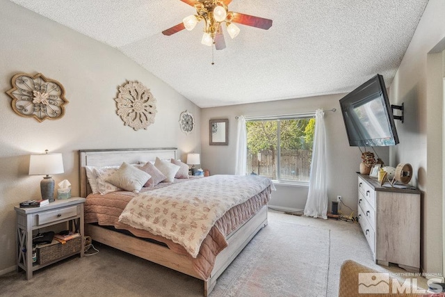bedroom featuring baseboards, vaulted ceiling, light carpet, a textured ceiling, and ceiling fan