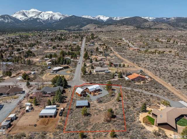 drone / aerial view featuring a rural view, a mountain view, and view of desert