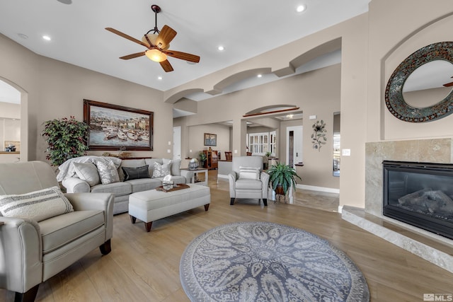 living room with recessed lighting, light wood-type flooring, and ceiling fan