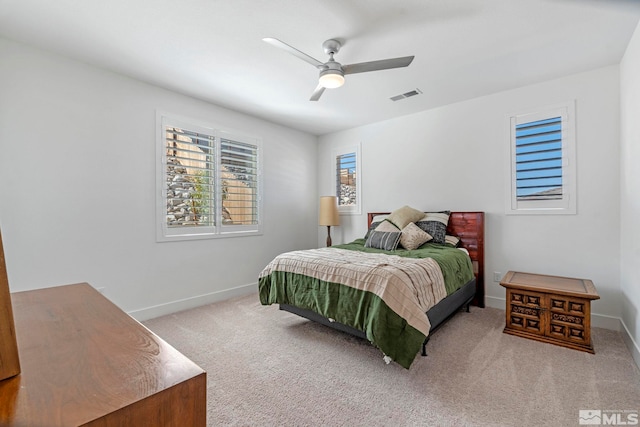 carpeted bedroom featuring ceiling fan, baseboards, and visible vents