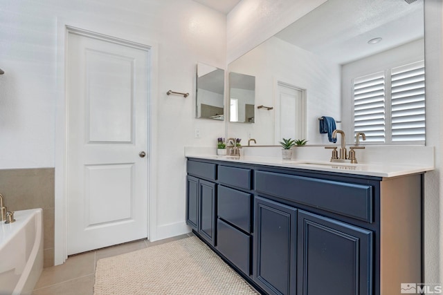 bathroom with a bath, double vanity, a sink, and tile patterned flooring