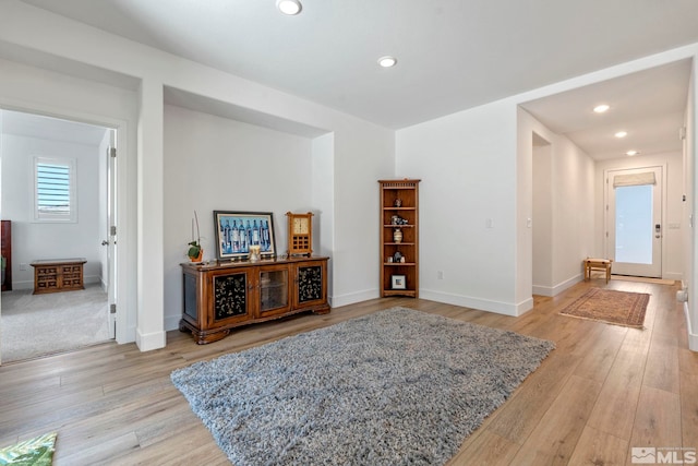 sitting room featuring light wood-type flooring, baseboards, and recessed lighting