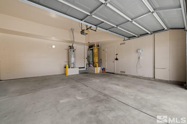 garage with water heater, gas water heater, and a garage door opener