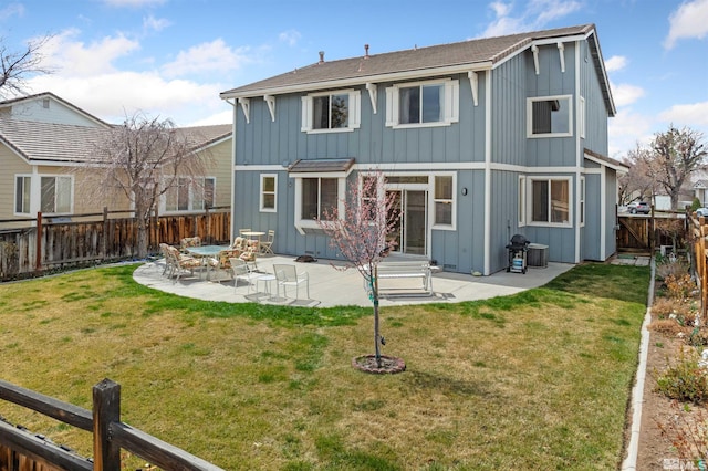 back of house with a patio area, a fenced backyard, board and batten siding, and a lawn