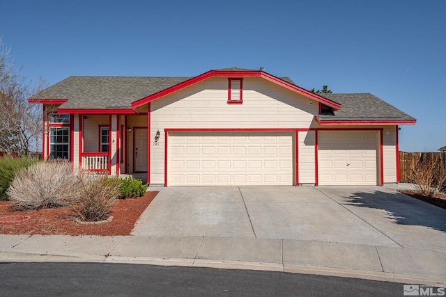 ranch-style home featuring roof with shingles, a garage, and concrete driveway