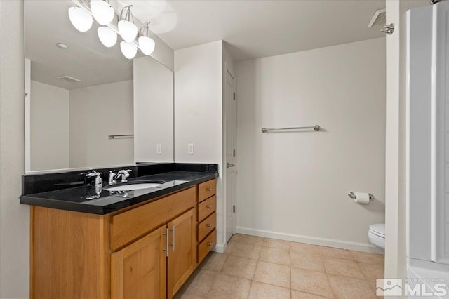 bathroom featuring toilet, vanity, baseboards, and visible vents