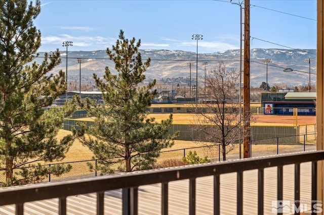 view of water feature with a mountain view and a fenced backyard