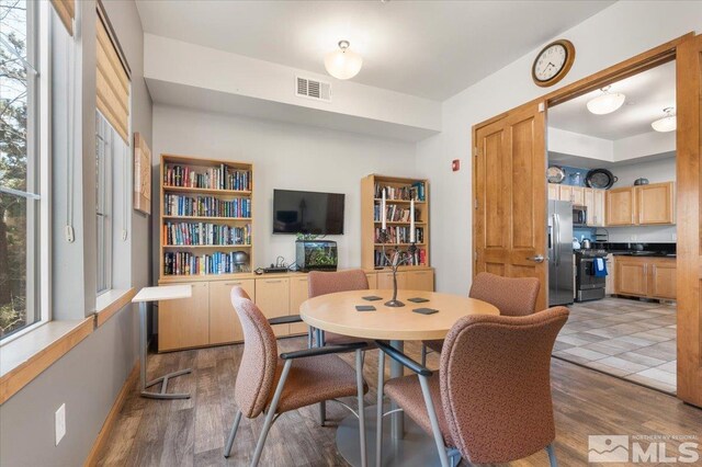 dining space featuring wood finished floors and visible vents