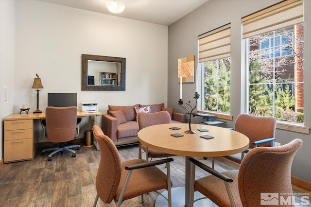 dining space with dark wood finished floors