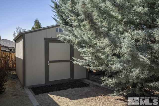 view of shed with fence