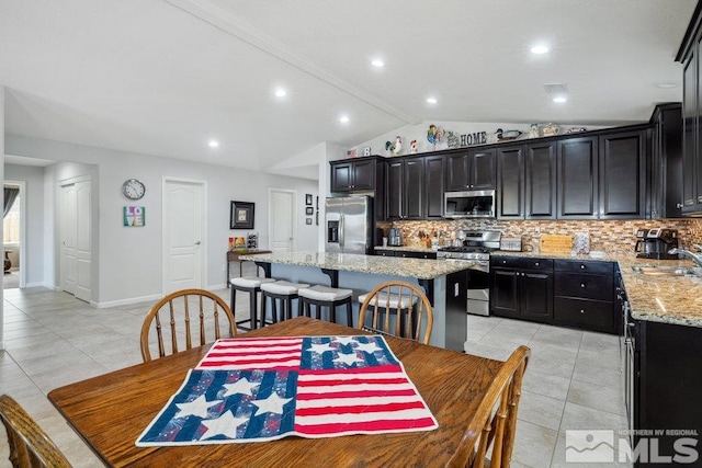 dining space with recessed lighting, light tile patterned floors, baseboards, and lofted ceiling