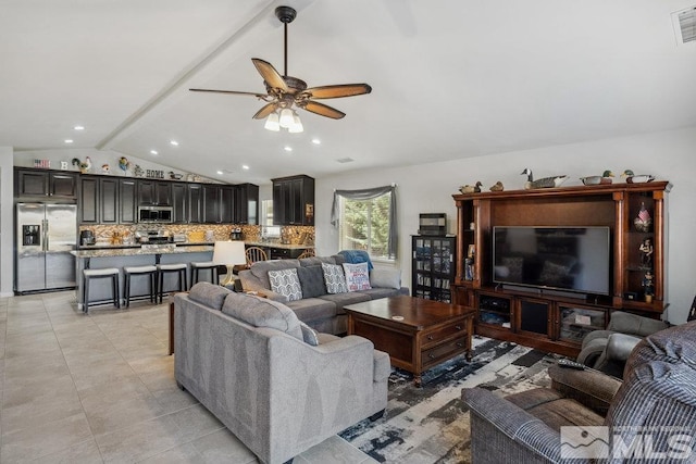 living area featuring visible vents, ceiling fan, lofted ceiling with beams, and light tile patterned floors