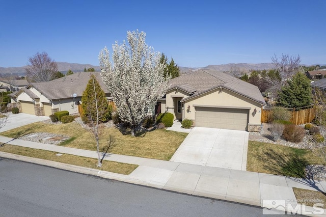 single story home with a tiled roof, stucco siding, a front yard, a garage, and driveway