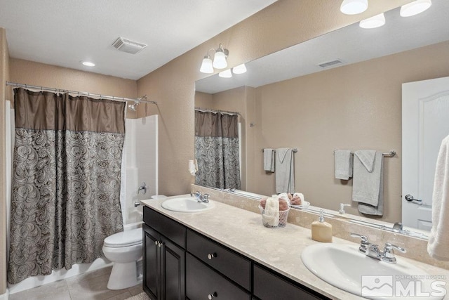 bathroom featuring tile patterned flooring, visible vents, a sink, and toilet