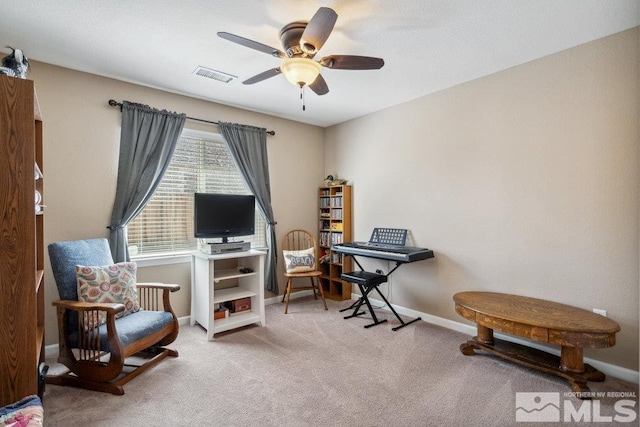 sitting room featuring visible vents, ceiling fan, carpet, and baseboards