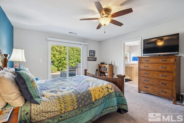 carpeted bedroom with ensuite bath, visible vents, access to exterior, and a ceiling fan