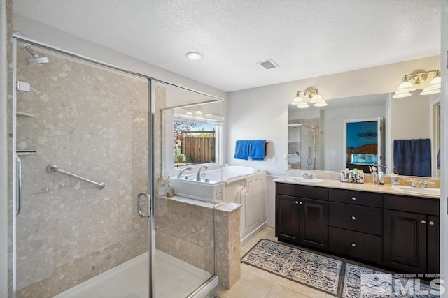 full bathroom with a shower stall, a bath, a sink, and visible vents