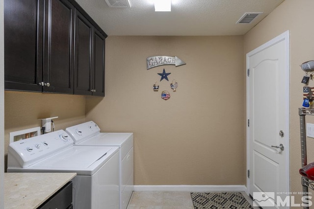 clothes washing area featuring cabinet space, visible vents, independent washer and dryer, and baseboards