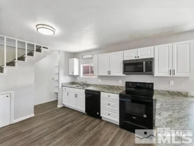 kitchen featuring white cabinets, baseboards, a sink, dark wood-style floors, and black appliances