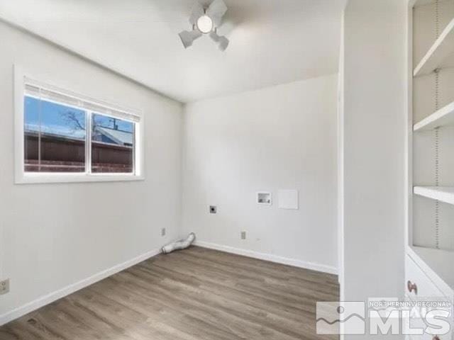 clothes washing area featuring laundry area, wood finished floors, baseboards, and hookup for a washing machine