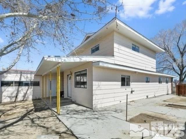 back of house with a patio and fence