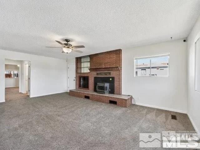 unfurnished living room featuring a textured ceiling, carpet flooring, and a ceiling fan