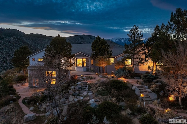view of front facade with a mountain view and stone siding