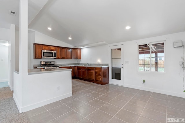 kitchen featuring stainless steel appliances, recessed lighting, light countertops, and vaulted ceiling