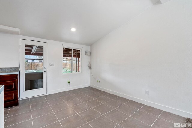 empty room with tile patterned floors, baseboards, and recessed lighting