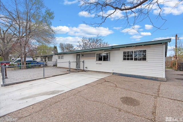 ranch-style house with fence and driveway