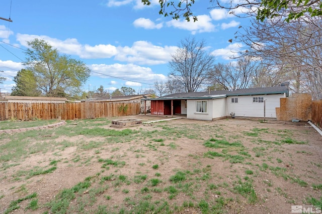 back of property featuring a fenced backyard and a vegetable garden