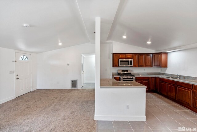 kitchen with visible vents, recessed lighting, a sink, lofted ceiling, and stainless steel appliances