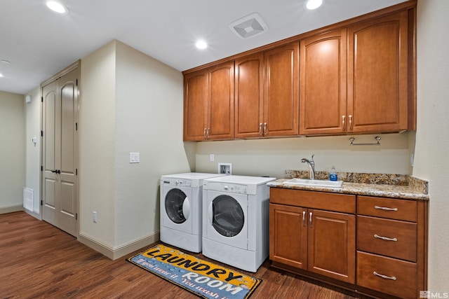 laundry room featuring visible vents, baseboards, washer and dryer, a sink, and dark wood finished floors